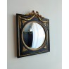 Miroir de sorcière dans cadre noir et détails or style empire