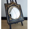 Miroir de sorcière dans cadre noir et détails or style empire